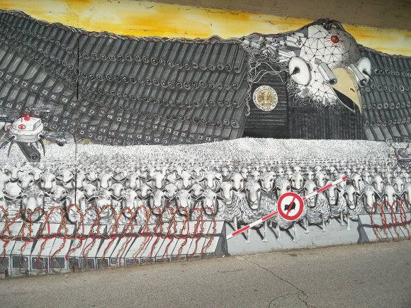 A giant NSA/CIA eagle, complete with drones, watches over the Sheeple. (Ehrenfeld, Köln)